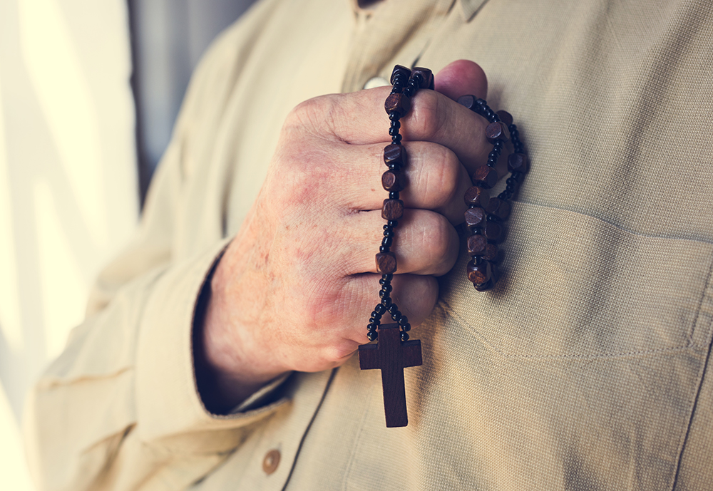 Hands holding cross prayer faith in christianity religion